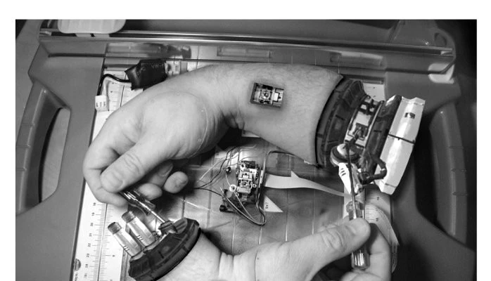 Two mechanical hands fixing each other